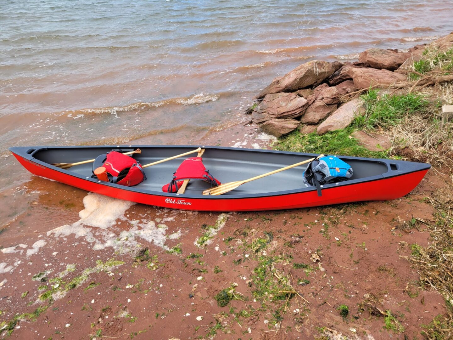 A Red Color Canoe on the River Side