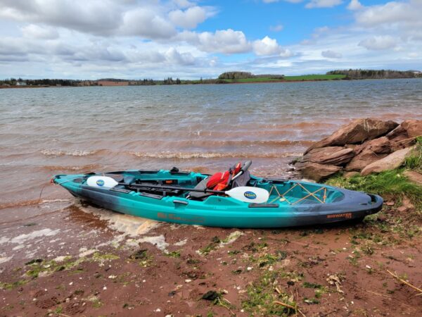 A Blue Color Canoe on the River Bed Cross One